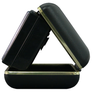 A black hard-shell travel case with a hinged lid, shown open to display its interior and exterior. The case features a polished gold-tone metal trim along the hinge and edge.