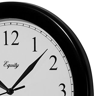 Close-up frame image of the 25203 10-inch Basics Wall Clock - Black. The clock features a black frame with a white dial, black numbers, and black metal hands.