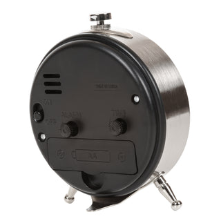 The back view of a round alarm clock with a brushed silver metal body and a black plastic backplate. The backplate features control knobs for fan, alarm, and time, along with a battery compartment labeled 'AA'.