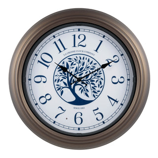 403-3246BR Lux lighted indoor outdoor wall clock featuring a center image of a tree and Arabic numbers on a white and blue dial surrounded by a brown frame