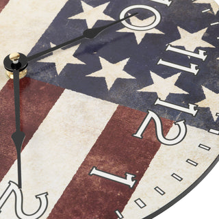 Top-down detail image of the 404-2631F 12-inch Flag Wall Clock showing the hands and the detail of the dial. The clock features an image of the American flag with white numbers, with no lens and black metal hands.