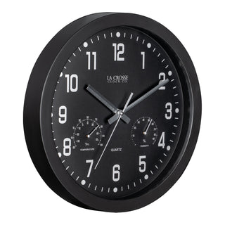 Right-facing view of the 404-2631 12-inch Inkwell Wall Clock with a black flush mount frame surrounding a black dial with white numbers, thermometer that reads both Fahrenheit and Celsius, and a Humidity gauge, featuring silver metal hour, minute, and second hands