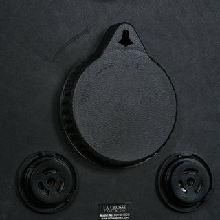 Close-up back image of the 404-3015CC 15-inch Indoor/Outdoor Payton Wall Clock showing the battery compartment cover on and the temperature and humidity adjustments.