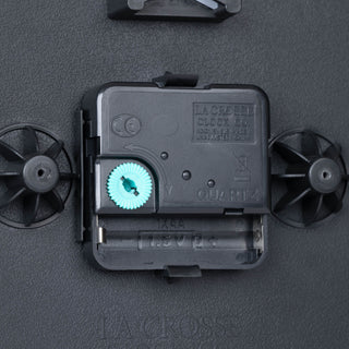 Close-up image of the back of the 404-3020B 8-inch Basics Analog Wall Clock – Black showing the battery compartment, the quartz movement, and the hanging hole.