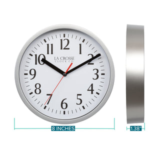 Dimension image in inches and centimeters of the 404-3020S 8-inch Basics Analog Wall Clock – Silver featuring a silver flush-mount frame, a white dial with black numbers, black hour and minute hands, and a red second hand. The clock is 8.0 inches in diameter and 1.38 inches deep.