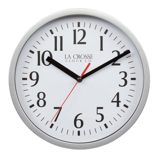 Head-on image of the 404-3020S 8-inch Basics Analog Wall Clock – Silver featuring a silver flush-mount frame, a white dial with black numbers, black hour and minute hands, and a red second hand.