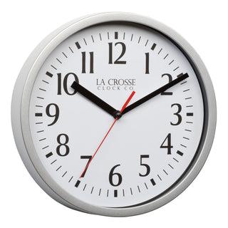 Right-facing image of the 404-3020S 8-inch Basics Analog Wall Clock – Silver featuring a silver flush-mount frame, a white dial with black numbers, black hour and minute hands, and a red second hand.