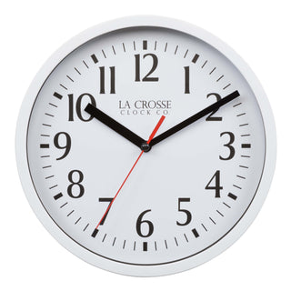 Head-on image of the 404-3020W 8-inch Basics Analog Wall Clock – White. The clock features a white flush-mount frame, a white dial with black numbers, black hour and minute hands, and a red second hand.