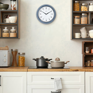404-3024IB Kitchen interior with a clock on the wall, pots on the stove, and shelves with jars and cups.