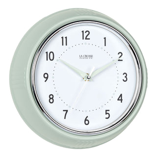 Right-facing image of the 404-3024PH 9.5-inch Diner Wall Clock - Pistachio. The clock features an off-white dial with black numbers, pistachio hour dots, pistachio hour and minute hands, and a silver accent second hand set within a vintage-retro pistachio green frame.