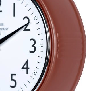 Close-up frame image of the 404-3024TC 9.5-inch Diner Clock – Terracotta features a retro-style terracotta frame with a white dial, chrome bezel, black numbers and minute markings, black metal hands, and a silver second hand.