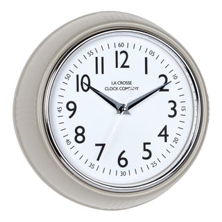 Right-facing image of the 404-3024TP 9.5-inch Diner Clock – Taupe. The clock features a retro-style taupe frame with a white dial, chrome bezel, black numbers and minute markings, black metal hands, and a silver second hand.