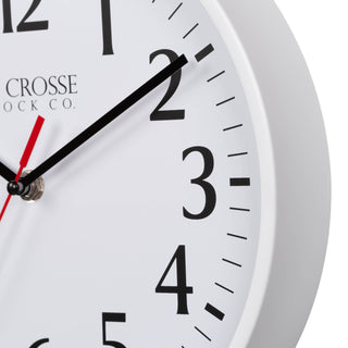 Close-up image of the White frame of the 404-3025W 10-inch Basic Decor Wall Clock with a white dial, black numbers, hour, minute hands, and a red second hand