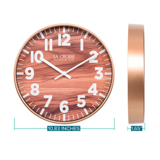 Orthographic image of the 10.8-inch Atwood Wall Clock featuring a copper finish frame, a wood design dial, white numbers, and white metal hour and minute hands. The dimensions are displayed as 10.83-inches in diameter with a depth of 1.65-inches.