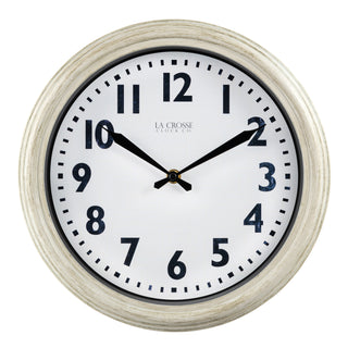 Head-on image of the 404-3030W 12-inch Wynn Wall Clock featuring an off-white weathered frame surrounding a white dial with distressed black numbers and decorative black metal hands with the La Crosse Clock logo.