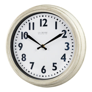 Left-facing image of the 404-3030W 12-inch Wynn Wall Clock featuring an off-white weathered frame surrounding a white dial with distressed black numbers and decorative black metal hands with the La Crosse Clock logo.