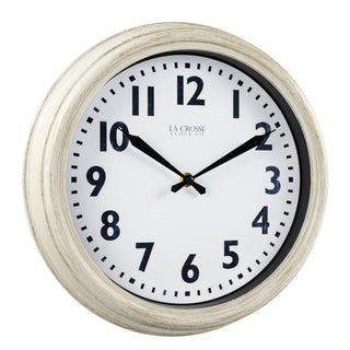 Right-facing image of the 404-3030W 12-inch Wynn Wall Clock featuring an off-white weathered frame surrounding a white dial with distressed black numbers and decorative black metal hands with the La Crosse Clock logo.