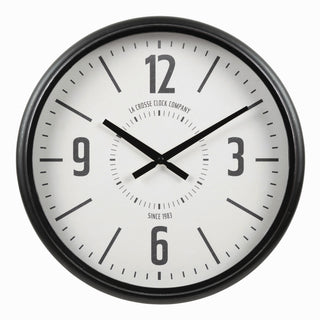 A round wall clock with a black frame and a white face, featuring bold black Arabic numerals and hands. The brand name 'LA CROSSE CLOCK COMPANY' is printed on the clock face.