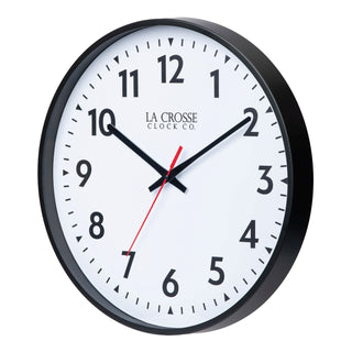 A left facing round wall clock with black frame and white face with black hour and minute hands and a red second hand.