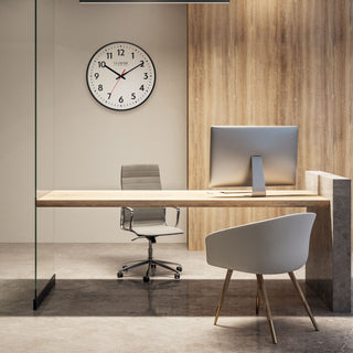 Modern office space with a La Crosse Clock Co. 19-inch wall clock, desk, chair, and computer.