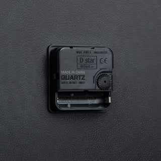 Back view of the 404-3048 19-inch commercial wall clock silent sweep quartz movement, battery compartment, and the easy control time wheel.