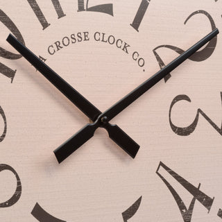 404-3053 Close-up of a wall clock face with black hands and distressed black numerals on a light beige wood background. The text 'CROSSE CLOCK CO.