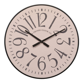 A round wall clock with a light beige textured face, large black Arabic numerals, black hands, and a black outer rim on a white background. The brand name 'A CROSSE CLOCK CO.