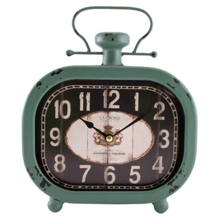 404-3425 A vintage-style metal alarm clock with a distressed sage green body, black face, and distressed cream numerals. The clock features a top handle, two feet, and the brand name 'La Crosse Clock CO' printed on the center dial.