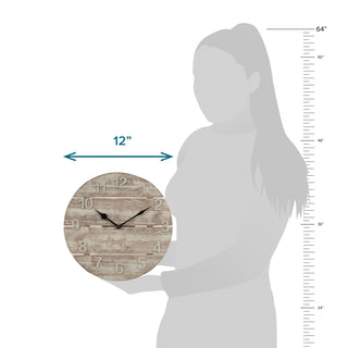 404-3430W Round wall clock with a rustic wood plank face and black hands, shown next to a gray silhouette of a person for scale, with a 12-inch width arrow and inch measurements on the right.