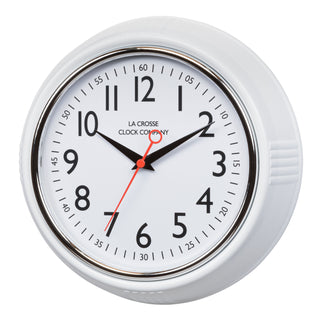 Left-facing image of the 404-3624W 9.5-inch Diner Clock – White. The clock features a retro-style white frame with a white dial, chrome bezel, black numbers and minute markings, black metal hands, and a red second hand.