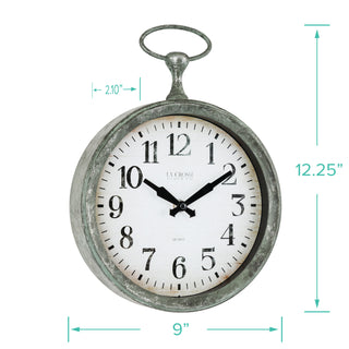 A vintage-style round wall clock with a distressed metal frame, white face, black numerals and hands, and a hanging loop at the top. Teal dimension arrows and labels show the clock is approximately 9 inches wide, 12.