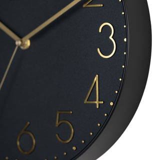 Close-up image highlighting the frame of the 404-3831B 12-inch Paxton Wall Clock - Black, with Silent Sweep, featuring a flush-mount black frame, a matching color dial, brass raised numbers, and brass-finished hour, minute, and second hands.