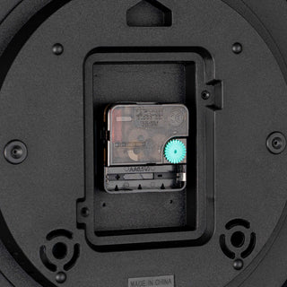 Close-up image of the back of the 12-inch 404-3832 Felix Cork Wall Clock showing the movement, the battery compartment, and the hanging hole.