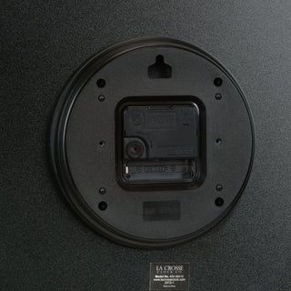 Back view of a black clock 404-3841C with branding on a dark background