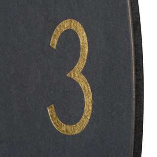 Gold number '3' on a dark textured background