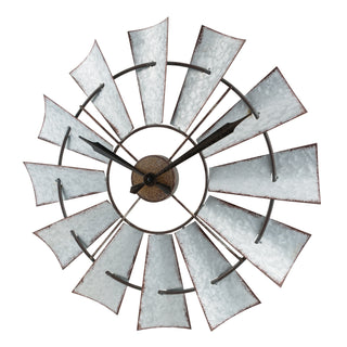 404-3956 A rustic metal windmill-style wall clock with distressed galvanized steel blades and dark metal hands, shown against a plain white background.