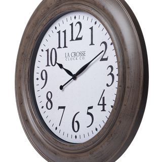 404-4292 A round wall clock with a distressed brown wood-look frame, a white dial face, and black numerals and hands. The brand name 'LA CROSSE CLOCK CO.
