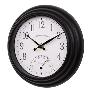 Left-facing image of the 433-3020B 8-inch Colby Indoor/Outdoor Wall Clock with temperature featuring a dark decorative frame, a white dial with black numbers, a Fahrenheit temperature gauge, and black metal hands.