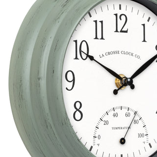 Wall clock with white face and greenish-grey casing, featuring La Crosse Clock Co. branding.