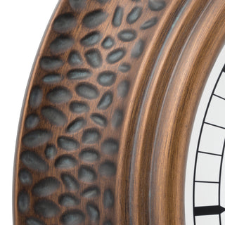Close-up of a rustic wooden clock frame with a hammered pebble texture and a white clock face partially visible on the right.