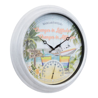 433-3841MV1T A round wall clock with a distressed white frame and a tropical beach scene printed on the face. The design includes palm trees, a small airplane, beach chairs, a thermometer dial, and the text 'MARGARITAVILLE' and 'Changes in Latitudes Changes in Attitude'.