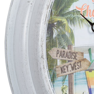 433-3841MV1T Close-up of a round wall clock with a distressed white frame and a tropical beach scene printed on the face, including palm trees, ocean, and wooden signs reading "PARADISE" and "KEY.WEST.
