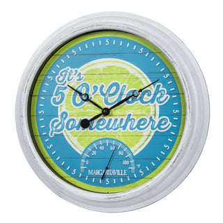 Left-facing image of the 433-3841MV2T 15.75-inch Margaritaville® Indoor Outdoor Wall Clock with Temperature. The clock features a lime green and teal blue dial with an image of a lime with the text "it's 5' O Clock Somewhere," a temperature gauge, and black hands all surrounded by a white weathered frame.