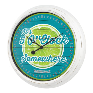 433-3841MV2 A round wall clock with a distressed white frame and a printed face featuring a lime slice graphic and the phrase 'It's 5 o'clock Somewhere' in stylized lettering, with 'MARCHDANDY' printed at the bottom.