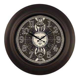 435-3256B-SM A round wall clock with a dark brown frame and a celestial moon face design on the dial, featuring black Arabic numerals and ornate black hands against a light gray background.