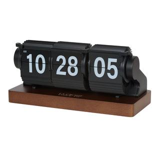 Left-facing image of the 536-526B Rollins Mechanical Tabletop Flip Clock features black flip cards, hour, minute, and seconds with white text mounted on a dark-stained wood base.