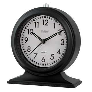 617-3014 A black round table clock with a white dial, black Arabic numerals, and black hands, shown on a plain white background. The brand name 'LA CROSSE CLOCK CO.