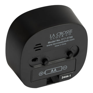 Back image of a tabletop alarm clock showing the dial functions battery compartment and depth of the black case with model number information screen printed in white displaying number 617-379B.