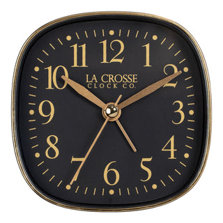 Head on image of a retro style La Crosse Clock Co table top alarm clock with black dial gold numbers and gold accents.