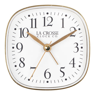 Head on image of a retro style La Crosse Clock Co table top alarm clock with white dial black numbers and gold accents.